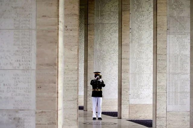 A Filipino soldier plays “Taps” on his trumpet along a hall of walls with names of “Missing in Action” soldiers during a Veterans Day ceremony at the Manila American Cemetery and Memorial in Taguig, Metro Manila, Philippines, 11 November 2022. Carlson joined the surviving war veterans in rites to honor American and Filipino troops killed in World War II at the cemetery, where more than 17,000 American military and 570 Filipino counterparts are buried. (Photo by Francis R. Malasig/EPA/EFE)