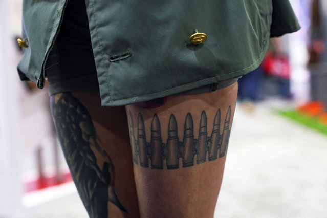 A tattoo on the leg of Miranda Stratton at the NRA annual meeting in Atlanta, Georgia, U.S. April 27, 2025. (Photo by Jeenah Moon/Reuters)