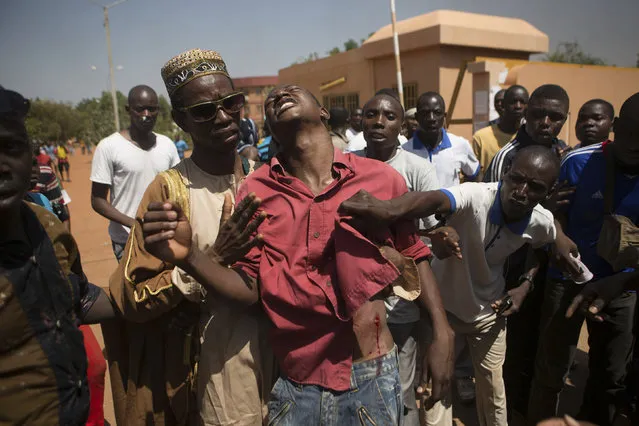 An anti-government protester is shot in Ouagadougou, capital of Burkina Faso, October 30, 2014. (Photo by Joe Penney/Reuters)