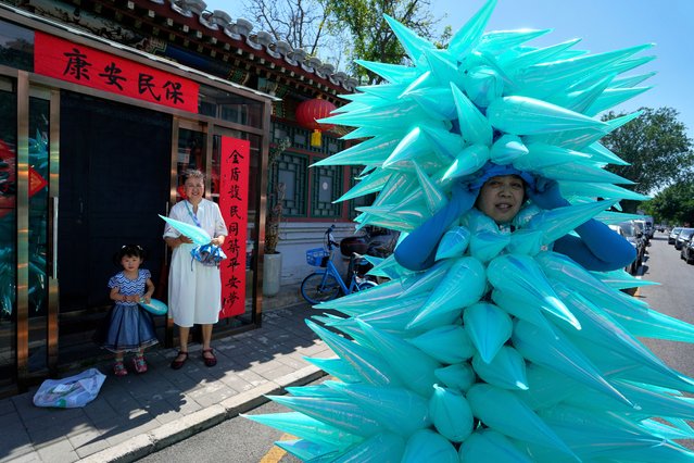 Chinese artist Kong Ning wears a piece entitled “Water Drop” to mark World Environment Day in Beijing, Thursday, June 5, 2025. (Photo by Ng Han Guan/AP Photo)