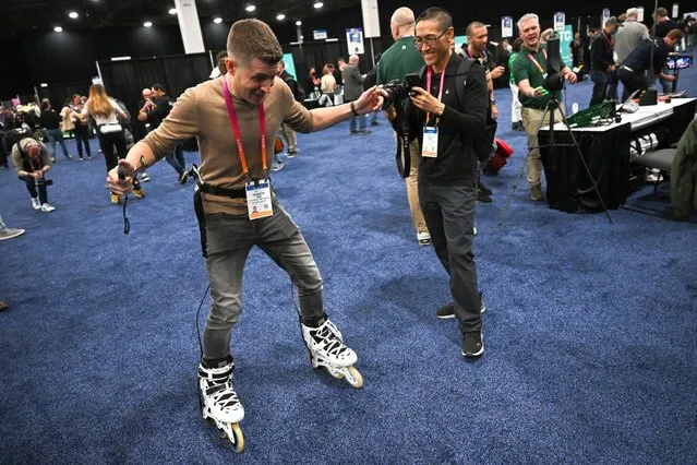 An attendee demonstrates the AtmosGear electric powered inline skates during CES Unveiled ahead of the Consumer Electronics Show (CES) of Las Vegas, Nevada on January 3, 2023. CES explores next-gen technology in the context of numerous topics, including 5G and IoT, advertising, automotive, block chain, health and wellness, immersive entertainment, robotics and more. 2023 CES will showcase more than 1400 exhibiting companies. (Photo by Patrick T. Fallon/AFP Photo)