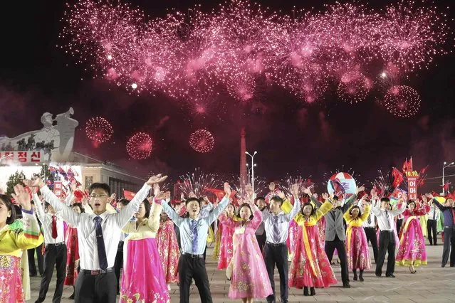 Youth and students attend an evening gala with firework display to celebrate the 77th founding anniversary of the Workers' Party of Korea at the Kim Il Sung Square in Pyongyang, North Korea Monday, October 10, 2022. (Photo by Jon Chol Jin/AP Photo)