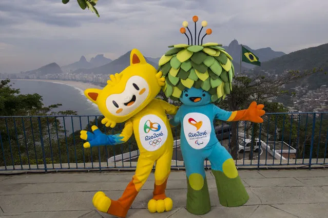 In this photo released by Rio 2016 Organizing Committee for the Olympic and Paralympic Games, the mascots of Rio 2016 Olympic, left, and Paralympic Games pose for a photo at the Leme Fort, with Copabana beach, left, in the background, in Rio de Janeiro, Brazil, Sunday, November 23, 2014. The Mascots are inspired by the Brazilian fauna and flora. (Photo by Alex Ferro/AP Photo/Rio 2016)