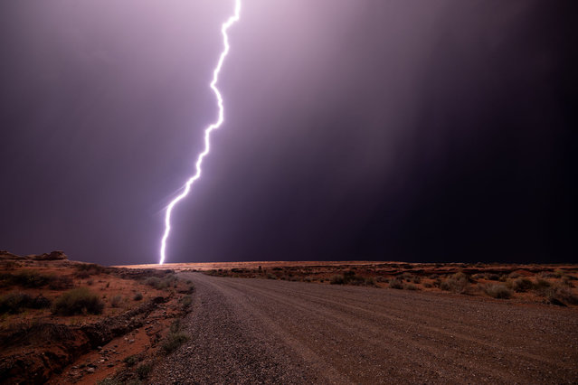 Lightning strikes as monsoon season storms bring desert-nourishing rain to Southwestern deserts on August 17, 2024 near Page, Arizona. A shift in wind direction from westerly to southerly typically triggers the American Southwest monsoon season by mid-June, and continuing through September, bringing storms of often-spectacular cloudbursts that produce widespread flash floods and dangerous lightning.  (Photo by David McNew/Getty Images)