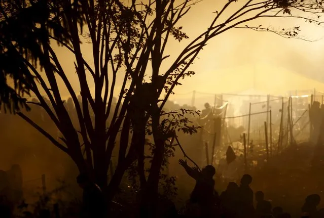 Migrants wait to cross the Slovenia-Austria border in Sentilj, Slovenia, October 27, 2015. (Photo by Srdjan Zivulovic/Reuters)