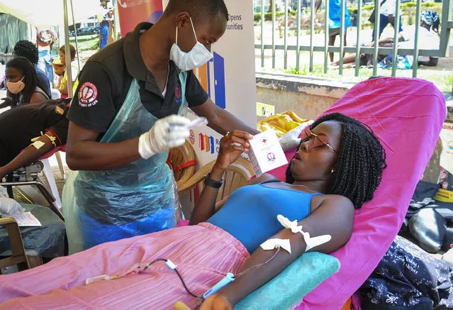 Aidah Kobusingye, right, gives blood at a blood-donation drive organized by the Rotary club and Uganda Blood Transfusion Services in City Square, Kampala, Uganda Saturday, September 19, 2020. Health authorities in Uganda say the supply of blood has sharply declined since the start of the coronavirus pandemic as fewer people donate and schools remain closed. Students, especially those in secondary school, are normally the largest group of blood donors in the East African country. (Photo by Ronald Kabuubi/AP Photo)