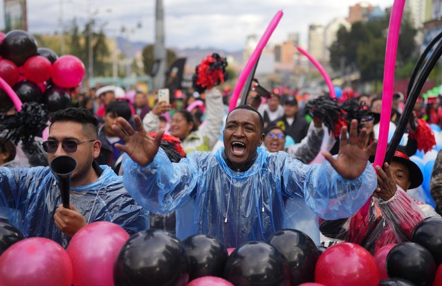 People cheer for their favorite contestant during the Queen of Great Power contest, in La Paz, Bolivia, Wednesday, May 1, 2024. The contest takes place ahead of the Festival of the Lord Jesus of Great Power, a street party that celebrates a rendering of Jesus Christ with native features and outstretched arms. (Photo by Juan Karita/AP Photo)