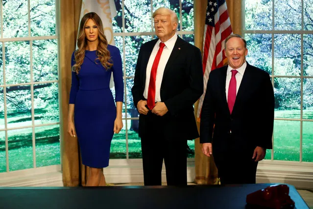 Former White House Press Secretary Sean Spicer poses next to a newly unveiled wax figure of first lady Melania Trump standing next to a wax figure of her husband, President Donald Trump, at the Madame Tussauds in New York, April 25, 2018. (Photo by Mike Segar/Reuters)
