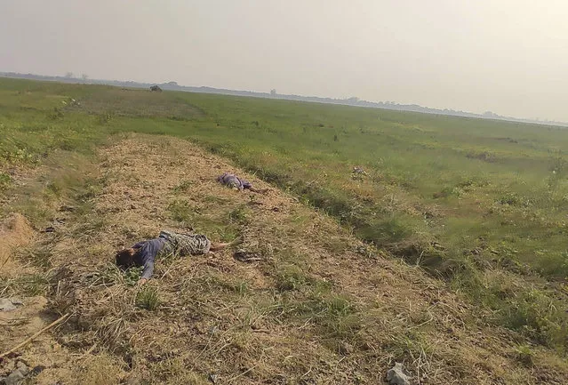 The bodies of two individuals lie on a field in Nyaung Yin village, Myinmu township in the Sagaing region, central Myanmar on Thursday, March 2, 2023. Soldiers in Myanmar rampaged through several villages, raping, beheading and killing at least 17 people, residents said, in the latest of what critics of the ruling military say are a series of war crimes since the army seized power two years ago. (Photo by UGC via AP Photo)
