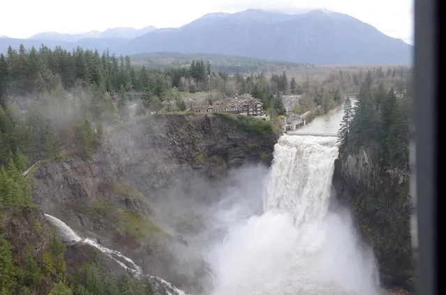 A torrent of water from Snoqualmie Falls is shown in this aerial photo taken by the Washington National Guard SSG Virginia M. Owens, November 18, 2015 and released to Reuters November 19, 2015. About 185,000 homes and businesses remained without power in Washington state late on Wednesday, after a storm blew down trees and triggered mudslides and flooding, killing at least three people, authorities said. (Photo by SSG Virginia M. Owens/Reuters/Washington National Guard)