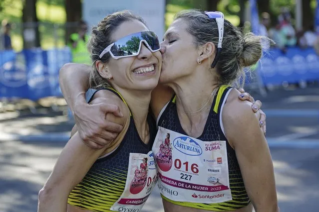 Serb national Ivana Zagorac, right and her twin sister Sladjana Zagorac kiss after Ivana won an amateur women's running race in Madrid, Spain, Sunday May 7, 2023. The organizers of a women's running race in Spain apologized on Monday,,May 8, 2023 after the winner was offered a food processor to take home, sparking accusations of sexism. (Photo by Carlos Lujan/Europa Press via AP Photo)