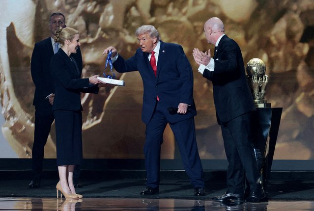 U.S. President Donald Trump is awarded the inaugural FIFA Peace Prize by FIFA President Gianni Infantino during the FIFA World Cup 2026 Draw at the John F. Kennedy Center for the Performing Arts in Washington on December 5, 2025. (Photo by Jonathan Ernst/Reuters)