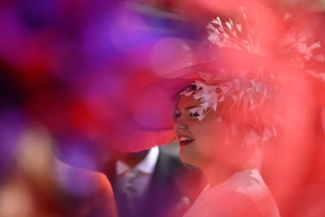 A racegoer smiles in the summer sunshine on Ladies Day, the third day of the Royal Ascot horse racing meeting in Ascot, west of London, on June 22, 2023. (Photo by Justin Tallis/AFP Photo)