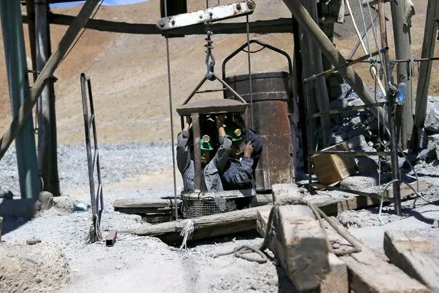 Artisanal miners emerge from Rodesia mine, a small copper mine, in the area of “Inca de Oro” (Inca Gold) town, near Copiapo city, north of Santiago, Chile, December 16, 2015. (Photo by Ivan Alvarado/Reuters)