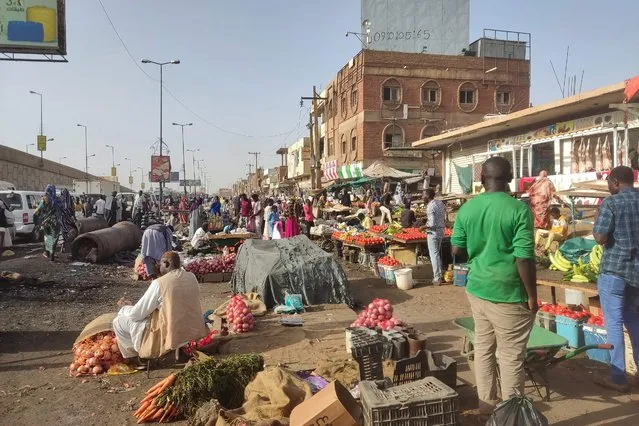 People sell fruits and vegetables in southern Khartoum, on May 24, 2023. Sporadic artillery fire still echoed in Sudan's capital but residents said fighting had calmed following a US and Saudi-brokered ceasefire, raising faint hopes in the embattled city. (Photo by AFP Photo/Stringer)