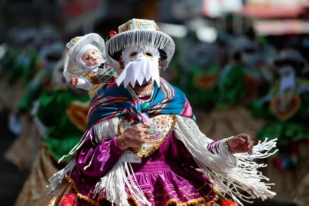 A woman attends a parade during a festival in honour of “Senor del Gran Poder” (Lord of Great Power) in La Paz, Bolivia on June 11, 2022. (Photo by Manuel Claure/Reuters)