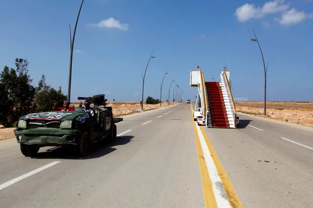 An abandoned VIP stairway is seen on a road at the airport in Sirte, which is now under the control of anti- Gaddafi fighters, September 29, 2011. Forces of Libya's interim government have captured the airport in Muammar Gaddafi's hometown of Sirte. (Photo by Anis Mili/Reuters)
