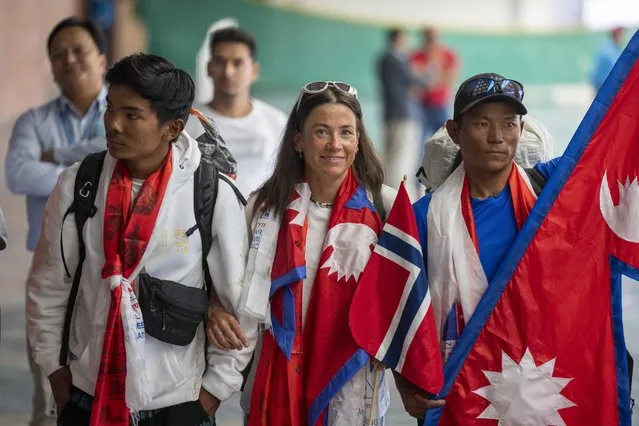 Norwegian woman mountain climber Kristin Harila, center and her Nepali Sherpa guide Tenjen Sherpa, right, who on Thursday set a new record by scaling the world's 14 highest peaks in 92 days arrive at the airport in Kathmandu, Nepal, Saturday, August 5, 2023. (Photo by Niranjan Shreshta/AP Photo)