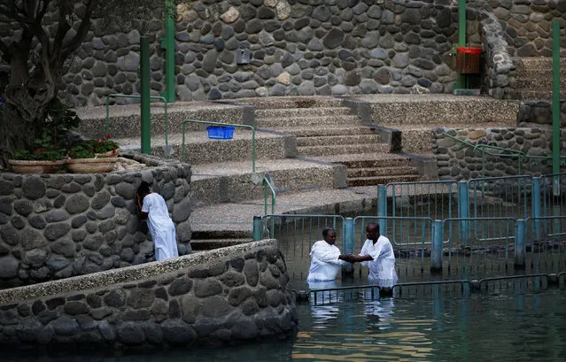 Christian tourists from Nigeria take part in a ceremony at the Yardenit baptismal site, in the Jordan River, which flows out from the Sea of Galilee, northern Israel November 30, 2016. (Photo by Ronen Zvulun/Reuters)