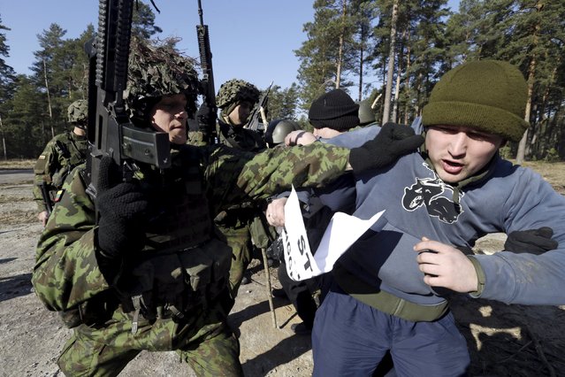 The Lithuanian Army's rapid reaction force unit carries out an anti-riot drill in Rukla March 19, 2015. The first rapid reaction force in Lithuania was formed in November 2014, in response to Russia's annexation of Crimea and the Ukraine crisis. (Photo by Ints Kalnins/Reuters)
