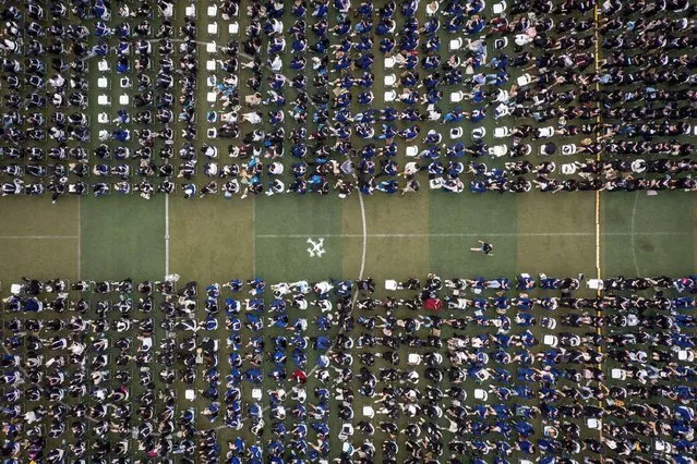 This aerial photo taken on June 13, 2021 shows nearly 9000 graduates, including more than 2000 students who could not attand the graduation ceremony last year due to the Covid-19 coronavirus outbreak, attanding a graduation ceremony at Central China Normal University in Wuhan, in China's central Hubei province. (Photo by AFP Photo/China Stringer Network)