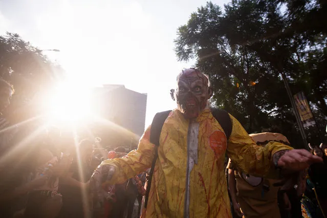 A person dressed as a zombie reacts during the annual Zombie Walk in Mexico City, Mexico on October 21, 2023. (Photo by Quetzalli Nicte-Ha/Reuters)