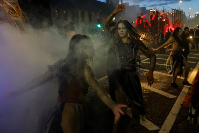 Members of street performance troupe Macnas perform during a Halloween parade called “Cnamha La Loba” in Galway, Ireland on October 29, 2023. (Photo by Clodagh Kilcoyne/Reuters)