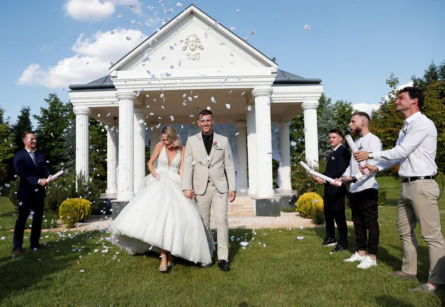 Bianka Uti and Patrik Dragoner celebrate their wedding ceremony as the coronavirus disease (COVID-19) restrictions are eased in Biri, Hungary, June 4, 2021. (Photo by Bernadett Szabo/Reuters)