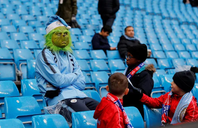 A Manchester City fan wears a Grinch mask before the  Premier League match between Manchester City and Crystal Palace at Etihad Stadium on December 22, 2018 in Manchester, United Kingdom. (Photo by Darren Staples/Reuters)