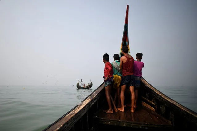 Rohingya refugees crew a fishing boat in the Bay of Bengal near Cox's Bazaar, Bangladesh, March 24, 2018. (Photo by Clodagh Kilcoyne/Reuters)