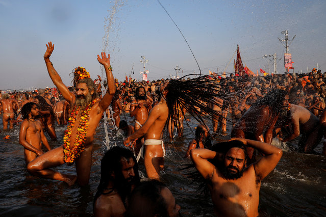 Naga Sadhus or Hindu holy men take a dip during the first “Shahi Snan” (grand bath) during “Kumbh Mela” or the Pitcher Festival, in Prayagraj, previously known as Allahabad, India, January 15, 2019. (Photo by Danish Siddiqui/Reuters)