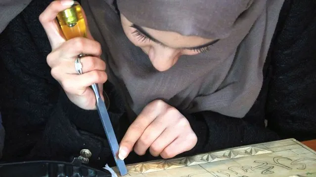 An Afghan girl crafts Nuristani carving at a workshop in Herat, Afghanistan, 29 November 2023. A group of four girls is dedicated to preserving the ancient art of Nuristani carving in Herat. Over the past three years, they have worked hard to produce colorful and intricate carvings, while also training numerous individuals in this traditional craft. Despite receiving daily orders from various provinces, they have noticed a decline in business compared to previous years. Nuristani carving has a rich history dating back to the Timurid period, and these girls are among the few in Herat working to keep this art form alive. (Photo by EPA/EFE/Stringer)