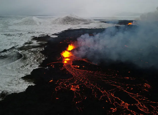 A drone picture shows lava spewing from the site of the volcanic eruption north of Grindavik, photographed from Sylingarfell, Iceland on December 19, 2023. (Photo by Sigurdur Davidsson/Reuters)