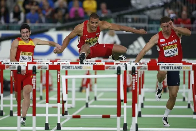 Ashton Eaton of the U.S. (C) clears a hurdle in a heat of the men's 60 meters hurdles portion of the Heptathlon at the IAAF World Indoor Athletics Championships in Portland, Oregon March 19, 2016. (Photo by Lucy Nicholson/Reuters)