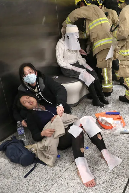 Injured people receive medical treatment inside a subway station in Hong Kong, China  February 10, 2017. (Photo by Apple Daily/Reuters)