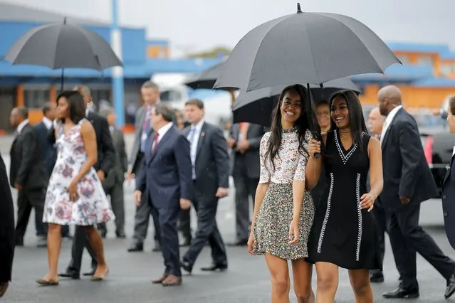 U.S. President Barack Obama's daughters Malia (C) and Sasha (R) arrive with their parents at the Jose Marti international airport at the start of a three-day visit to Cuba, in Havana March 20, 2016. (Photo by Carlos Barria/Reuters)