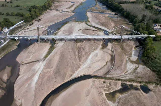 A view shows a bridge with sandbanks of a branch of the Loire River in Loireauxence, France on October 17, 2023. (Photo by Stephane Mahe/Reuters)