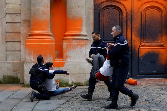 French gendarmes arrest environmental activists of “Derniere Renovation” (Last Renovation) group  after they sprayed paint on the facade of the Hotel Matignon to draw attention to climate change and to denounce the French State failure to not honor its climate commitments, in Paris, France on January 4, 2023. (Photo by Gonzalo Fuentes/Reuters)