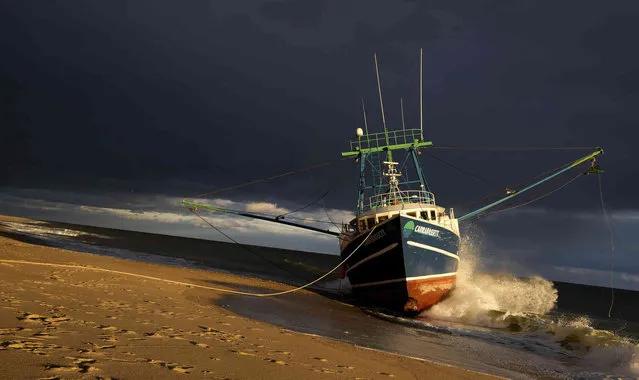 The Carrabassett, a New Bedford-based commercial fishing vessel sits grounded on Longnook Beach in Truro, Mass., Friday, December 3, 2021. Authorities are still working to free the boat which ran aground on Tuesday, November 30. (Photo by Virginia Mayo/AP Photo)