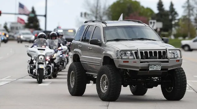 More than 600 Jeeps lead a caravan to the memorial service for Kendrick Castillo, who was killed in the assault on the STEM Highlands Ranch School, Wednesday, May 15, 2019, in Highlands Ranch, Colo. (Photo by David Zalubowski/AP Photo)