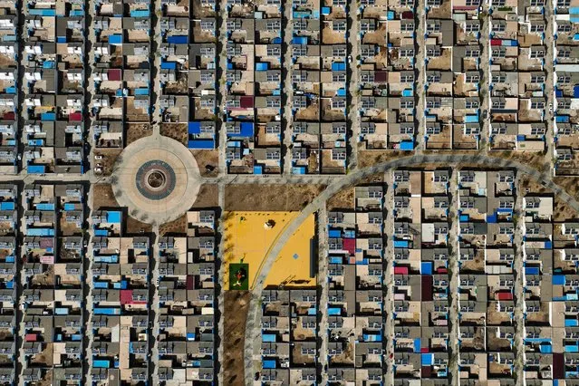 An aerial view shows residential buildings with roof-mounted photovoltaic solar panels in Yinchuan, in northwestern China's Ningxia region on March 31, 2024. (Photo by AFP Photo/China Stringer Network)