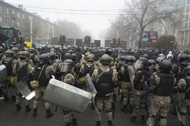 Riot police block a street to prevent demonstrators during a protest in Almaty, Kazakhstan, Wednesday, January 5, 2022. Demonstrators denouncing the doubling of prices for liquefied gas have clashed with police in Kazakhstan's largest city and held protests in about a dozen other cities in the country. (Photo by Vladimir Tretyakov/AP Photo)