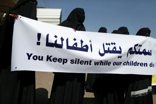 Women hold a banner as they take part in a protest marking the International Women's Day outside the United Nations offices in Sanaa, Yemen, March 8, 2017. (Photo by Khaled Abdullah/Reuters)