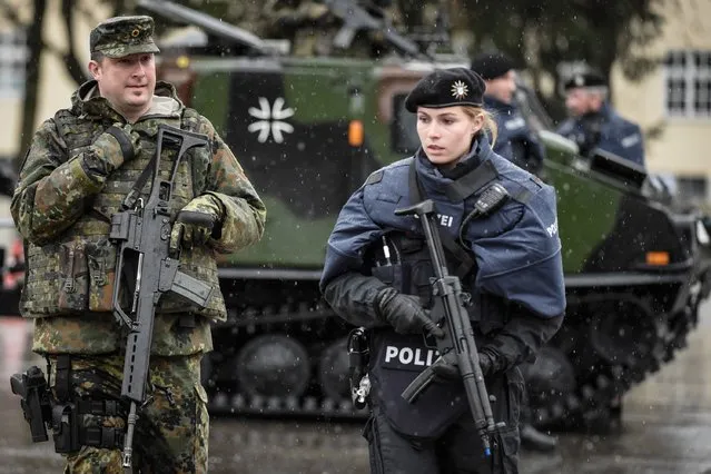 Members of the Bavarian police and the Bundeswehr, the German armed forces, guard a vehicle checkpoint as they demonstrate a dynamic operation as part of the GETEX anti-terror exercises during a media event on March 9, 2017 in Murnau, Germany. (Photo by Philipp Guelland/Getty Images)