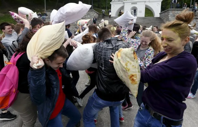 People take part in a pillow fight during a flash mob in Kiev, Ukraine, April 24, 2016. (Photo by Valentyn Ogirenko/Reuters)