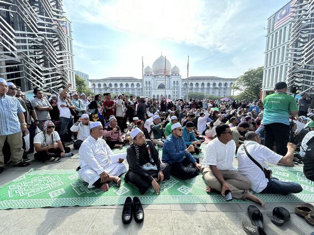 Members of the Pan-Malaysian Islamic Party wait outside the Palace of Justice, background, as they await the Federal Court's decision on Kelantan state's sharia law criminal enactment, in Putrajaya, Malaysia Friday, February 9, 2024. Malaysia's top court Friday struck down over a dozen Shariah-based state laws, saying they encroached on federal authority, a decision denounced by Islamists who fear it could undermine religious courts across the country. (Photo by AP Photo)