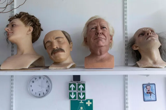 A picture taken on May 12, 2021 shows the head of US former President Donal Trump (2ndR) wax statue amongst other on a shelf at the Musee Grevin wax museum in Paris, ahead of its reopening following the closure as part of restrictions to fight the spread of the Covid-19 pandemic. (Photo by Thomas Samson/AFP Photo)