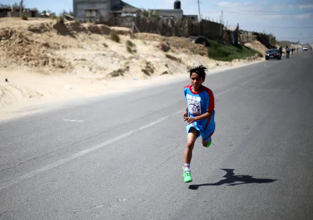 A Palestinian boy runs during a local marathon organized by Culture and Free Thought association, in Khan Younis in the southern Gaza Strip April 28, 2016. (Photo by Ibraheem Abu Mustafa/Reuters)