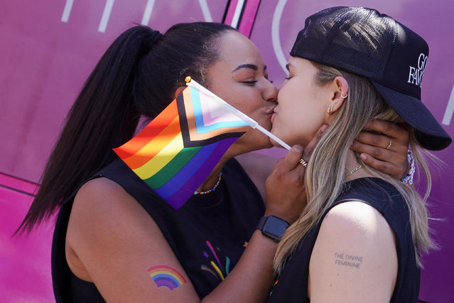 Cheyenne Catchpole and Erica Hill kiss during the annual LGBTQ+ Capital Pride parade in Washington on June 8, 2024. (Photo by Nathan Howard/Reuters)