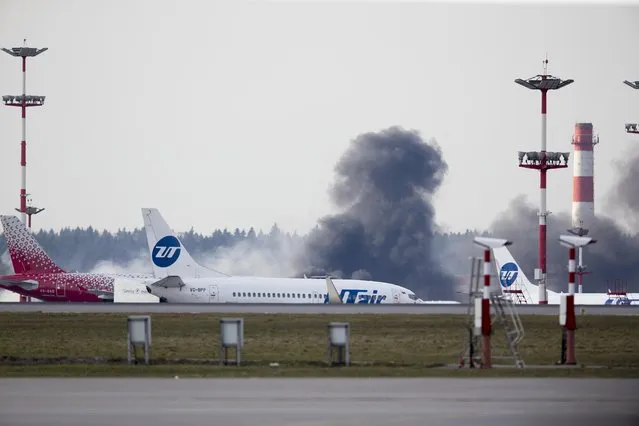 Smoke rises behind a runway in Moscow's Vnukovo airport, Russia, Tuesday, April 11, 2017, prior to the arrival of U.S. Secretary of State Rex Tillerson. Tillerson is due to meet with Russian Foreign Minister Sergey Lavrov on Wednesday. (Photo by Ivan Sekretarev/AP Photo)